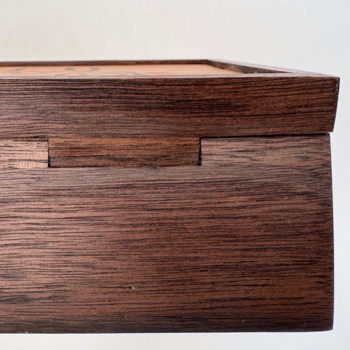 Close-up of a wooden hinge detail.